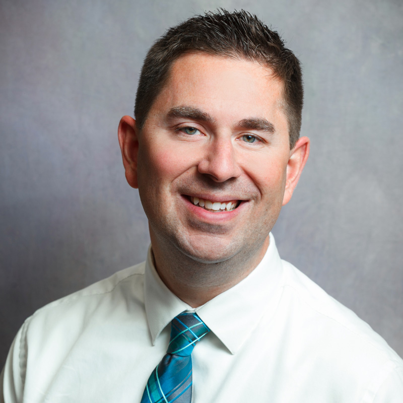 Dr. Mark Christian smiling at camera
